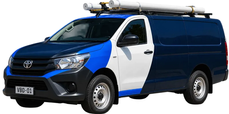 A licensed Cherrybrook plumbing van loaded with pipe on the roof rack